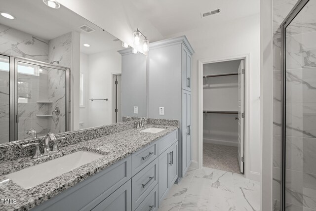 bathroom with vanity and a shower with shower door