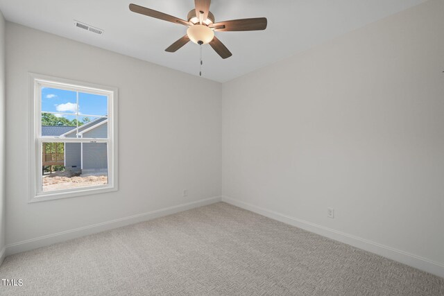 empty room featuring carpet flooring and ceiling fan