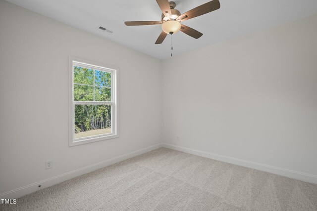 carpeted spare room with ceiling fan