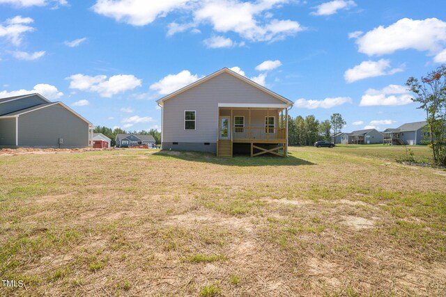 back of property with a lawn