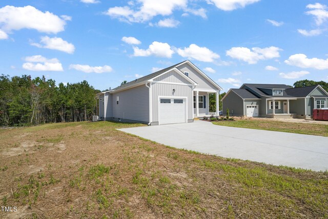 exterior space with a garage and a lawn