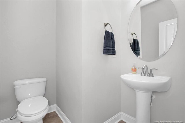 bathroom featuring tile patterned flooring and toilet