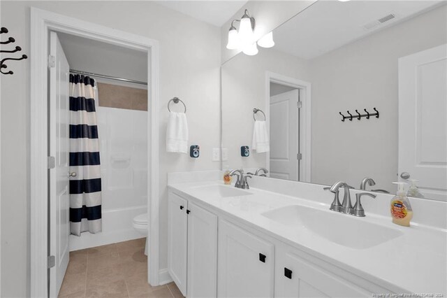 full bathroom with tile patterned flooring, vanity, toilet, and shower / tub combo