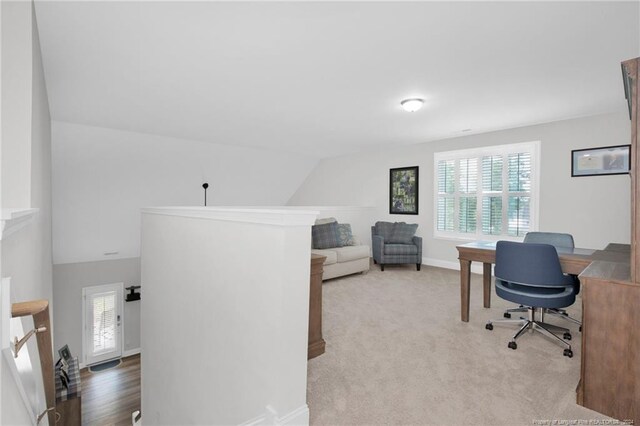 office with vaulted ceiling and light hardwood / wood-style flooring