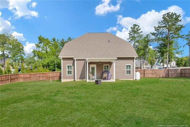 back of house featuring a yard and a patio area