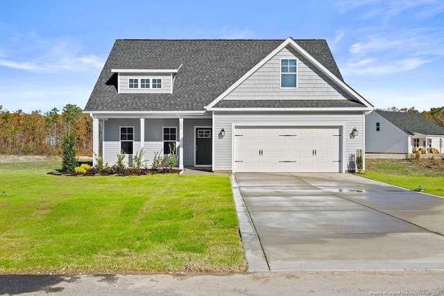 craftsman house featuring a front yard, a garage, and covered porch