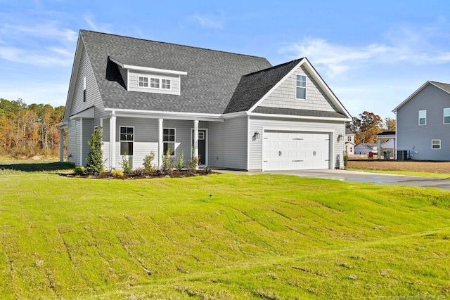 craftsman inspired home with central AC, a garage, and a front lawn