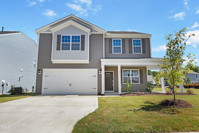 view of front of property featuring a garage, a front yard, and central AC