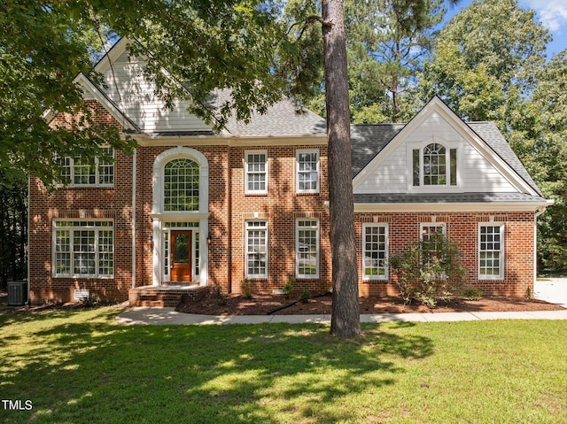 view of front of property featuring a front lawn and central air condition unit