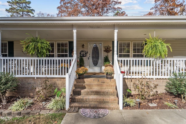 doorway to property featuring a porch