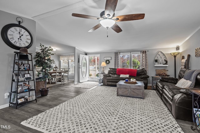 living room with ceiling fan, dark hardwood / wood-style flooring, and ornamental molding