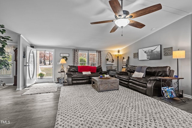 living room with vaulted ceiling, hardwood / wood-style flooring, and ceiling fan