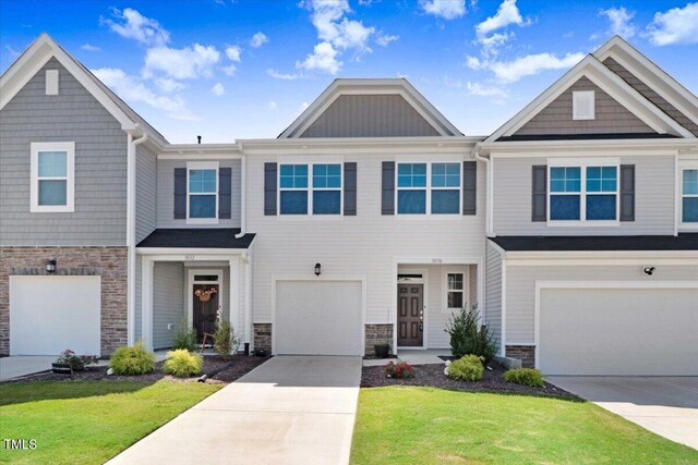 view of property featuring a front yard and a garage