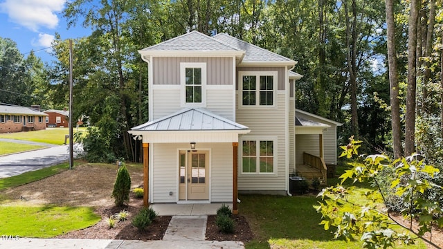 view of front facade featuring a front yard and cooling unit