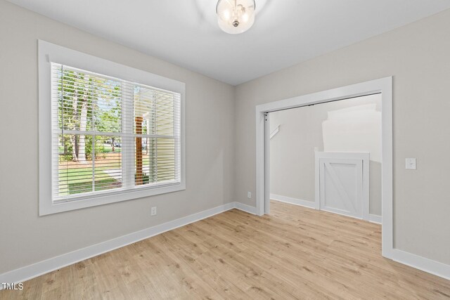 spare room featuring light hardwood / wood-style flooring