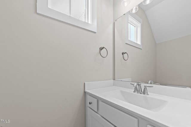 bathroom featuring vanity and vaulted ceiling