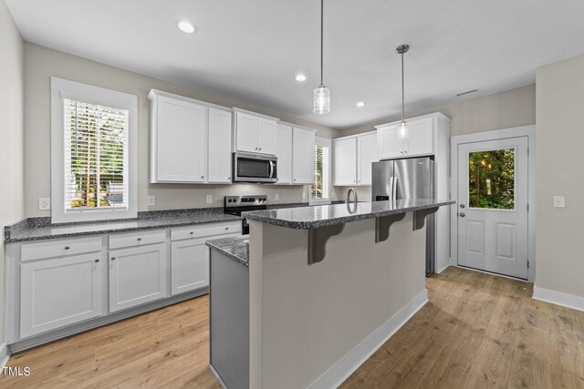 kitchen featuring light wood-type flooring, white cabinetry, and stainless steel appliances