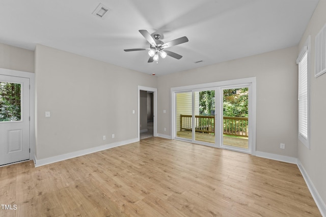 spare room with light hardwood / wood-style flooring, plenty of natural light, and ceiling fan