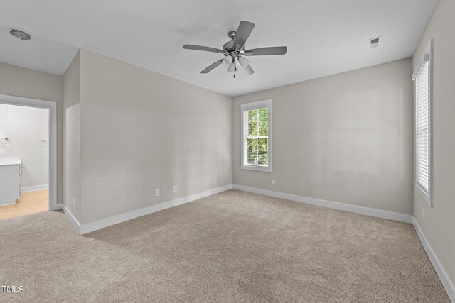 carpeted empty room with ceiling fan