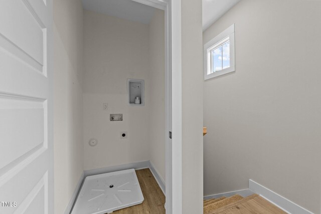 clothes washing area with washer hookup, hardwood / wood-style flooring, hookup for a gas dryer, and electric dryer hookup