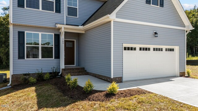 property entrance with central air condition unit and a garage