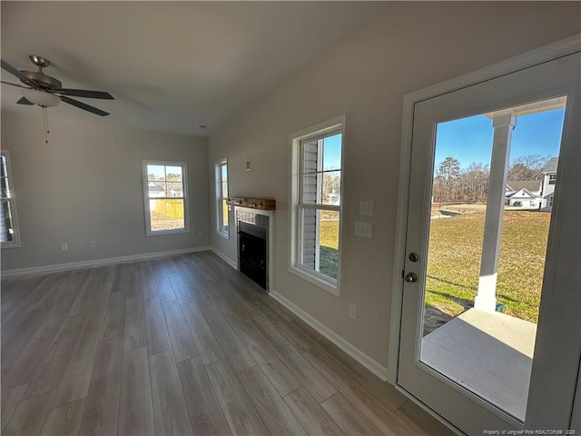 unfurnished living room with hardwood / wood-style flooring and ceiling fan