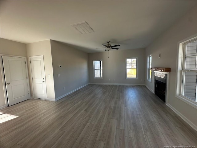 unfurnished living room featuring hardwood / wood-style floors and ceiling fan