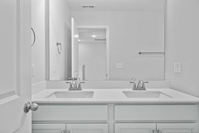 full bathroom with double vanity, a sink, and visible vents