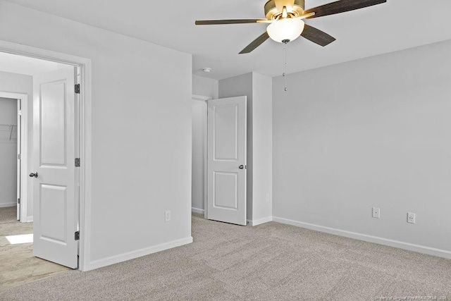 unfurnished bedroom featuring carpet flooring, a ceiling fan, and baseboards