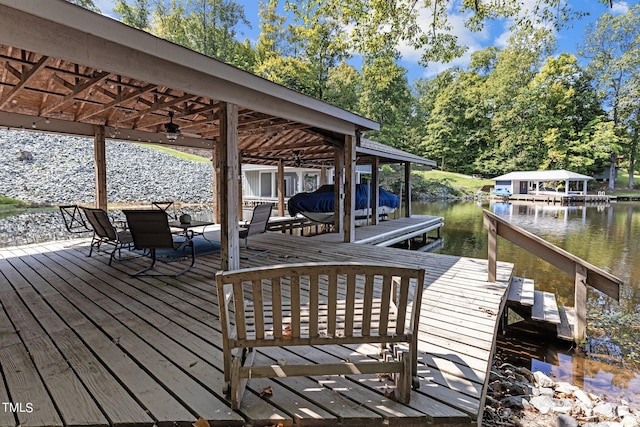 wooden terrace featuring a boat dock and a water view