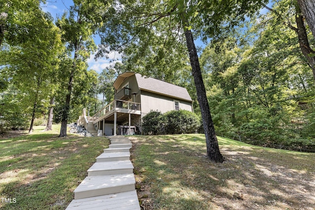 back of property featuring a yard and a deck