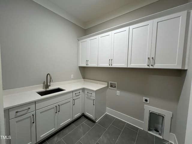 washroom featuring cabinets, hookup for an electric dryer, dark tile patterned floors, crown molding, and sink