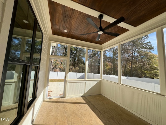 unfurnished sunroom with plenty of natural light, ceiling fan, and wood ceiling