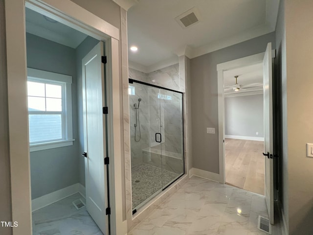 bathroom featuring a shower with door, ornamental molding, and ceiling fan