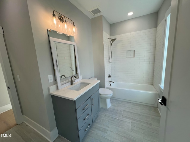 full bathroom with vanity, toilet, and tiled shower / bath