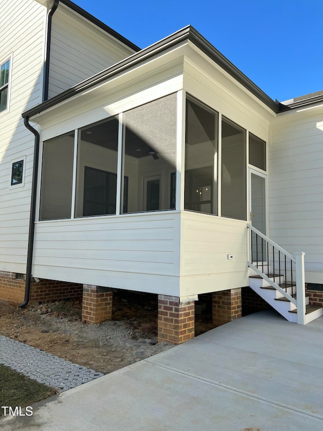 view of side of home featuring a sunroom