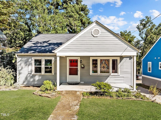 bungalow-style home featuring a front lawn