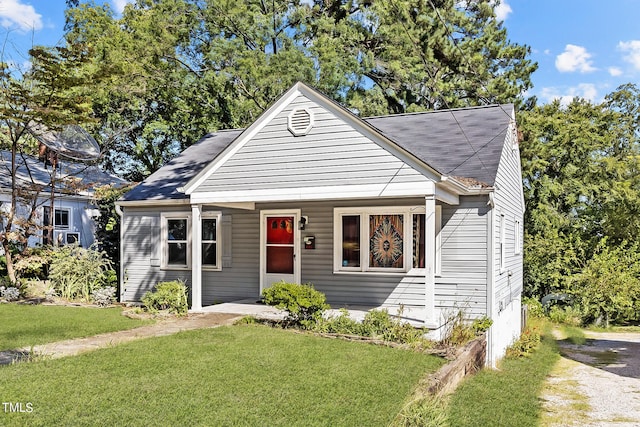 bungalow-style home featuring a front lawn