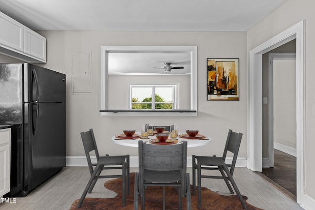 dining space with light hardwood / wood-style flooring and ceiling fan