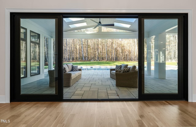 entryway with ceiling fan and wood-type flooring