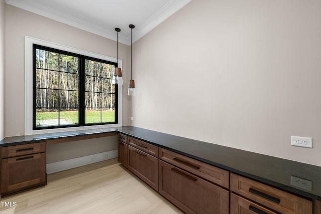 interior space with hardwood / wood-style flooring, built in desk, and crown molding