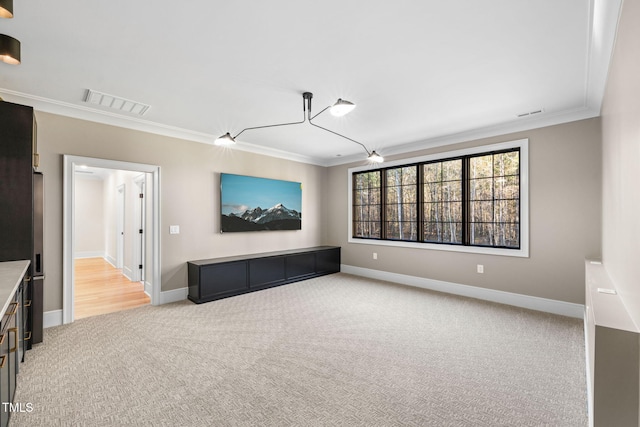 unfurnished living room featuring light colored carpet, ceiling fan, and ornamental molding