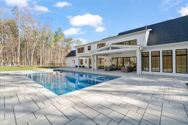 view of swimming pool with an outdoor hangout area, a patio, and ceiling fan