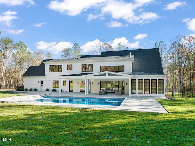 rear view of house featuring outdoor lounge area, a yard, and a patio