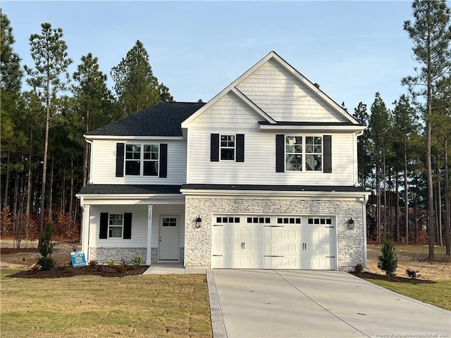 view of front property featuring a front lawn and a garage