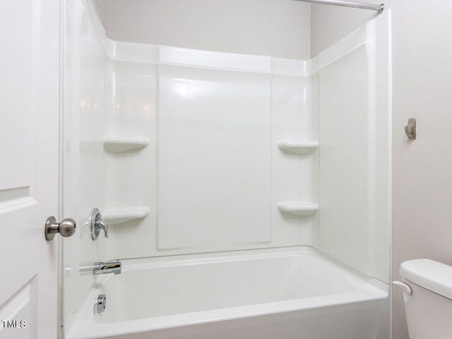 bathroom featuring toilet and shower / washtub combination