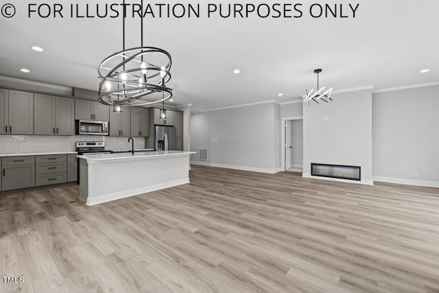102 Mayan Dr, Louisburg, NC 27549 - kitchen featuring a chandelier, gray cabinets, appliances with stainless steel finishes, and tasteful backsplash