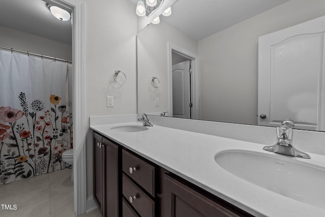 bathroom featuring vanity, toilet, a shower with shower curtain, and tile patterned flooring