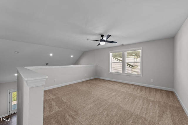 bonus room featuring lofted ceiling, plenty of natural light, ceiling fan, and carpet flooring