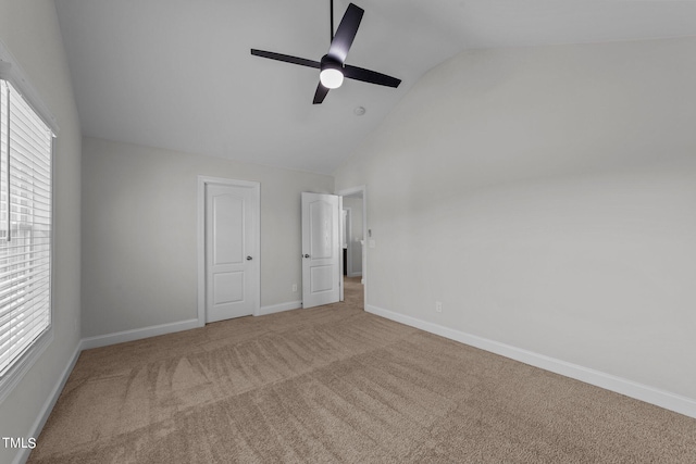 unfurnished bedroom featuring ceiling fan, carpet floors, and vaulted ceiling